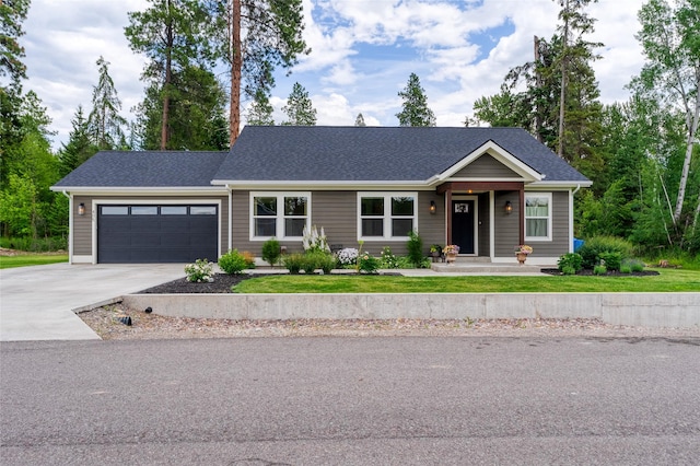 405 Kendal Loop, Kalispell, MT 59901 - view of front of house with concrete driveway, a garage, and a front lawn