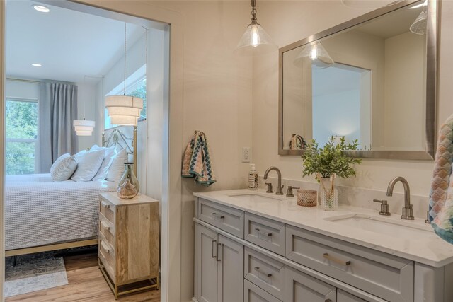 405 Kendal Loop, Kalispell, MT 59901 - ensuite bathroom featuring double vanity, wood finished floors, and recessed lighting