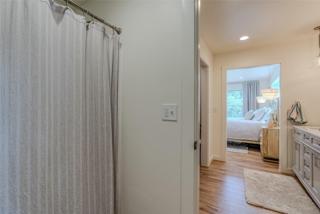 405 Kendal Loop, Kalispell, MT 59901 - full bathroom featuring wood finished floors, vanity, ensuite bath, a shower with curtain, and recessed lighting