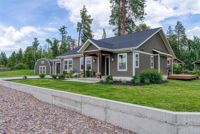 405 Kendal Loop, Kalispell, MT 59901 - ranch-style house with an attached garage, a shed, a front lawn, driveway, and a wooden deck