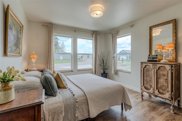405 Kendal Loop, Kalispell, MT 59901 - bedroom featuring wood finished floors and multiple windows