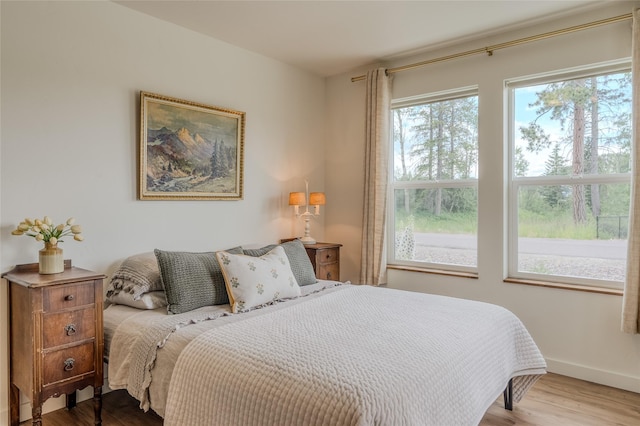 405 Kendal Loop, Kalispell, MT 59901 - bedroom featuring multiple windows and wood finished floors
