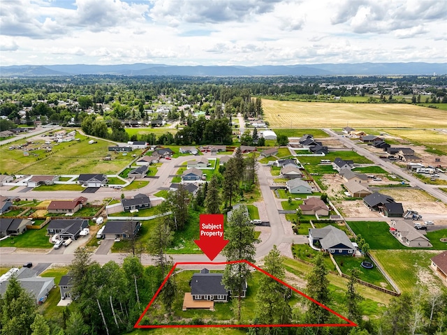 405 Kendal Loop, Kalispell, MT 59901 - aerial view of residential area featuring property parcel outlined and a mountain backdrop