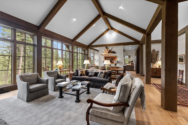 176 Whitefish Hills Loop, Whitefish, MT 59937 - living area with high vaulted ceiling, a chandelier, light wood-type flooring, and beam ceiling