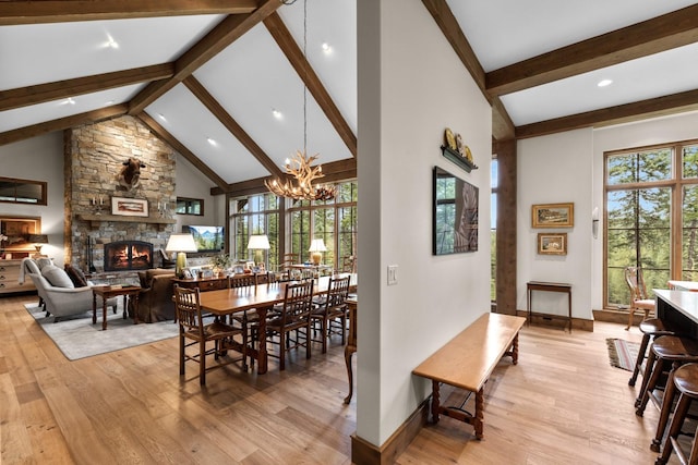176 Whitefish Hills Loop, Whitefish, MT 59937 - dining room featuring a fireplace, beam ceiling, light wood finished floors, a chandelier, and recessed lighting