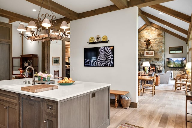 176 Whitefish Hills Loop, Whitefish, MT 59937 - kitchen with light wood-style floors, light countertops, a chandelier, pendant lighting, and open floor plan