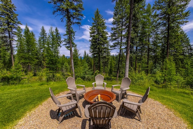 176 Whitefish Hills Loop, Whitefish, MT 59937 - view of patio / terrace with a fire pit and a view of trees
