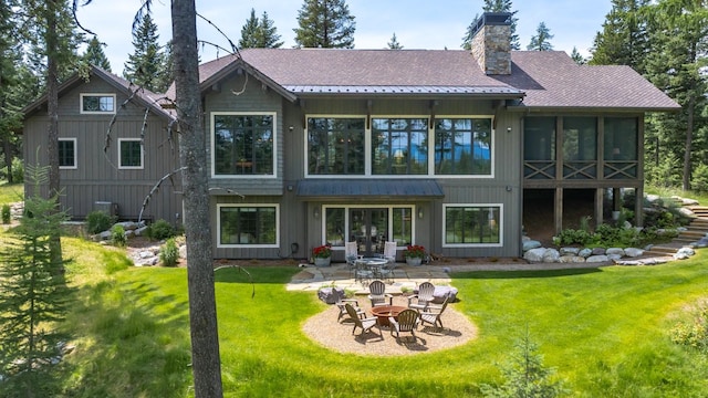 176 Whitefish Hills Loop, Whitefish, MT 59937 - back of property with an outdoor fire pit, a patio area, a yard, and a shingled roof