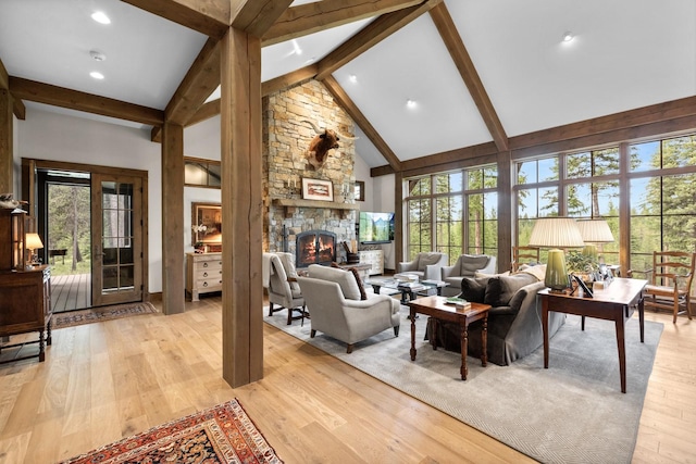 176 Whitefish Hills Loop, Whitefish, MT 59937 - living room featuring high vaulted ceiling, beam ceiling, light wood-style flooring, a fireplace, and recessed lighting