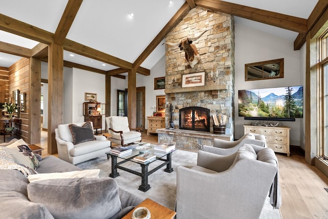 176 Whitefish Hills Loop, Whitefish, MT 59937 - living room with light wood-style flooring, a stone fireplace, beam ceiling, high vaulted ceiling, and recessed lighting