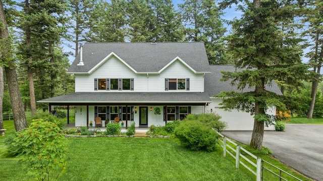 745 Capistrano Dr, Kalispell, MT 59901 - view of front of house featuring driveway, covered porch, an attached garage, and a shingled roof