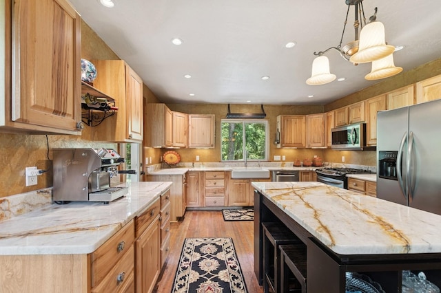 745 Capistrano Dr, Kalispell, MT 59901 - kitchen featuring stainless steel appliances, light wood finished floors, recessed lighting, light stone counters, and decorative backsplash