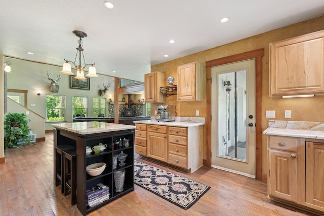 745 Capistrano Dr, Kalispell, MT 59901 - kitchen with open shelves, light brown cabinetry, recessed lighting, a center island, and light wood-style floors
