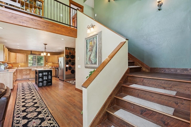 745 Capistrano Dr, Kalispell, MT 59901 - stairs featuring wood finished floors, a chandelier, and recessed lighting