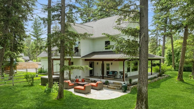 745 Capistrano Dr, Kalispell, MT 59901 - back of property with a shingled roof, an outdoor living space, and a patio