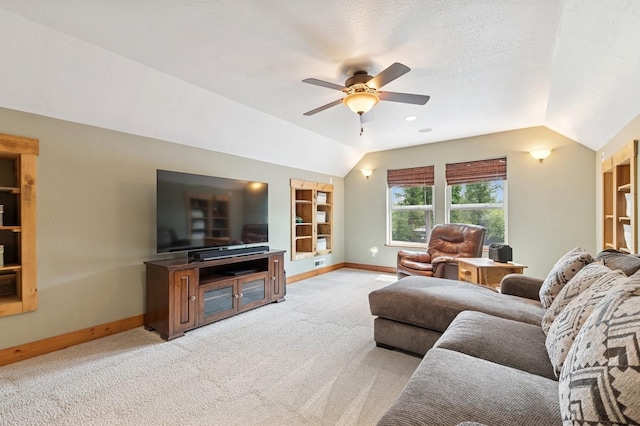 745 Capistrano Dr, Kalispell, MT 59901 - living room featuring lofted ceiling, ceiling fan, built in shelves, and light colored carpet