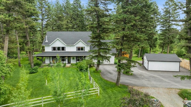 745 Capistrano Dr, Kalispell, MT 59901 - view of front of property featuring covered porch, driveway, a garage, a shingled roof, and view of wooded area