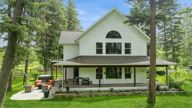 745 Capistrano Dr, Kalispell, MT 59901 - back of property featuring roof with shingles, an outdoor hangout area, covered porch, and a patio
