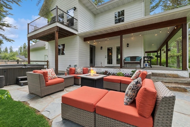 745 Capistrano Dr, Kalispell, MT 59901 - patio / terrace featuring a hot tub, an outdoor living space with a fire pit, and a patio