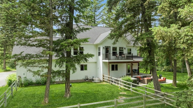 745 Capistrano Dr, Kalispell, MT 59901 - back of house with outdoor lounge area, a fenced backyard, a shingled roof, and a patio