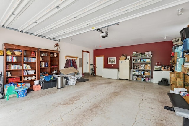 745 Capistrano Dr, Kalispell, MT 59901 - garage with freestanding refrigerator, a garage door opener, and electric panel