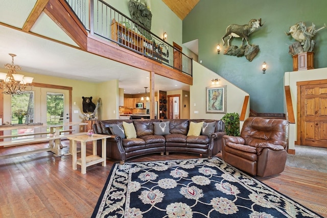 745 Capistrano Dr, Kalispell, MT 59901 - living room with a chandelier, wood finished floors, high vaulted ceiling, and stairs