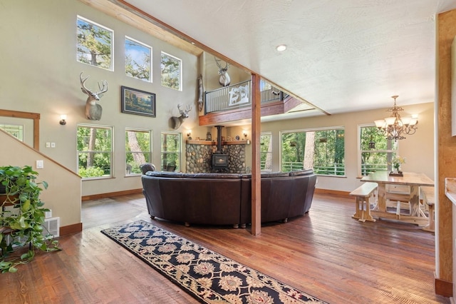 745 Capistrano Dr, Kalispell, MT 59901 - living area with wood finished floors, a chandelier, and a wood stove