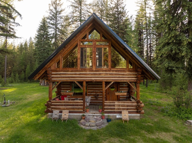 235 Red Meadow Rd, Polebridge, MT 59928 - view of front of home with log exterior, a front yard, a view of trees, and stairway