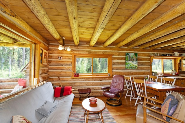 235 Red Meadow Rd, Polebridge, MT 59928 - living area featuring log walls, healthy amount of natural light, a wood ceiling with exposed beams, and wood finished floors