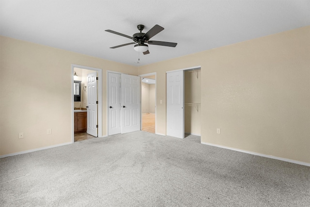 4012 Lancaster Rd, Missoula, MT 59808 - unfurnished bedroom with carpet flooring, two closets, connected bathroom, and ceiling fan