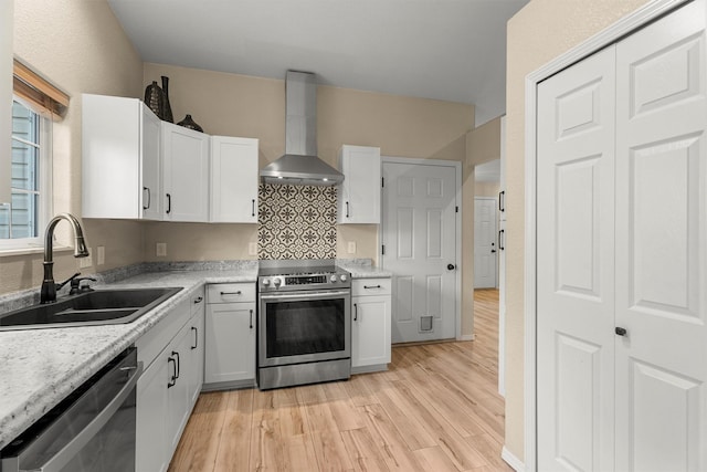 4012 Lancaster Rd, Missoula, MT 59808 - kitchen featuring wall chimney range hood, stainless steel appliances, light wood-style floors, and light countertops