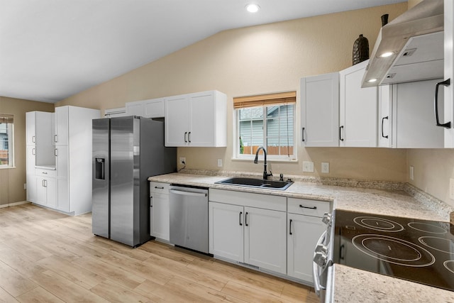 4012 Lancaster Rd, Missoula, MT 59808 - kitchen featuring stainless steel appliances, extractor fan, vaulted ceiling, white cabinetry, and light wood-style flooring
