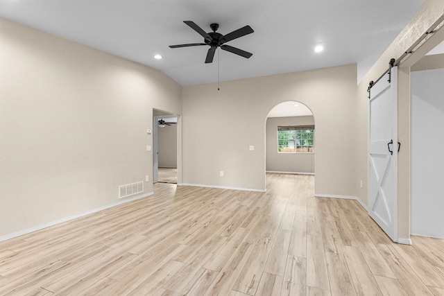 4012 Lancaster Rd, Missoula, MT 59808 - empty room featuring a barn door, ceiling fan, light wood finished floors, recessed lighting, and arched walkways