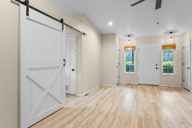 4012 Lancaster Rd, Missoula, MT 59808 - entryway featuring a barn door, light wood-type flooring, ceiling fan, and recessed lighting