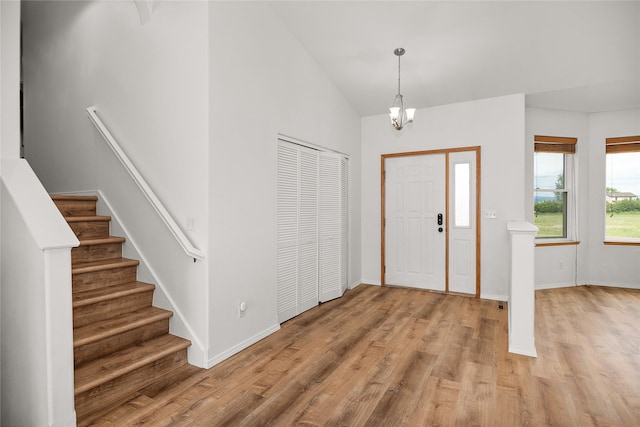 3477 Birkland Dr, Helena, MT 59602 - entrance foyer with light wood-type flooring, stairway, a chandelier, and high vaulted ceiling