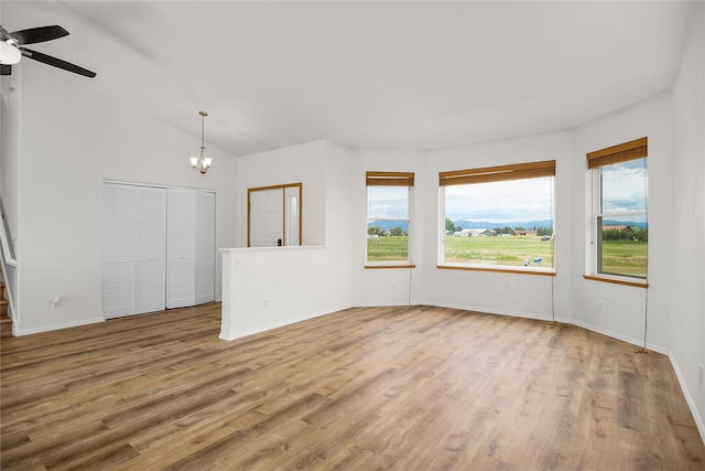 3477 Birkland Dr, Helena, MT 59602 - unfurnished room featuring wood finished floors, a ceiling fan, a chandelier, and vaulted ceiling