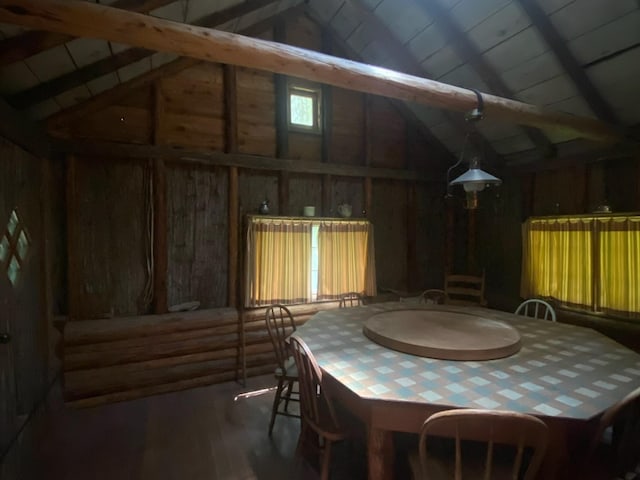 489 Grist Rd, West Glacier, MT 59936 - dining space featuring high vaulted ceiling, wood finished floors, wooden walls, and beam ceiling