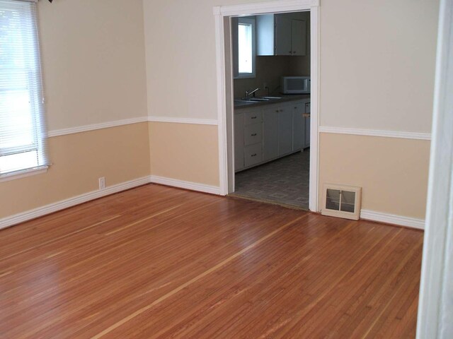 905 3rd Ave E, Kalispell, MT 59901 - empty room with wood finished floors and healthy amount of natural light