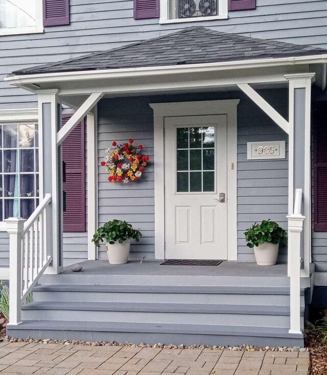 905 3rd Ave E, Kalispell, MT 59901 - doorway to property with covered porch and a shingled roof