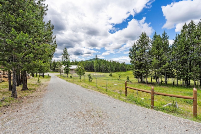 71 Cw Mitchell Ct, Marion, MT 59925 - view of dirt / gravel road featuring a view of countryside and a mountain view