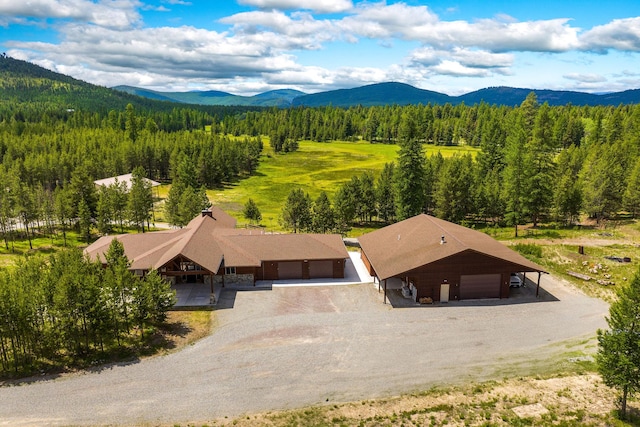 71 Cw Mitchell Ct, Marion, MT 59925 - view of subject property with a mountain backdrop and a heavily wooded area