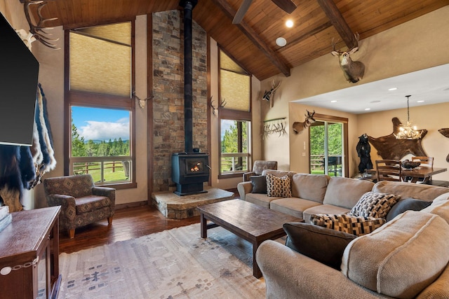 71 Cw Mitchell Ct, Marion, MT 59925 - living area with a wood stove, a wood ceiling with exposed beams, high vaulted ceiling, light wood-type flooring, and a chandelier