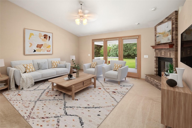 133 Trailridge Rd, Kalispell, MT 59901 - living room featuring light colored carpet, vaulted ceiling, a fireplace, and a ceiling fan