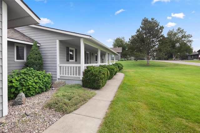 133 Trailridge Rd, Kalispell, MT 59901 - view of side of property featuring a porch and a lawn