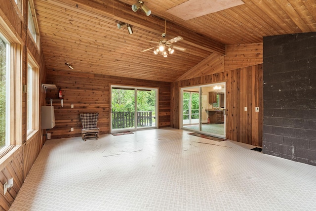 1255 Tamarack Ln, Columbia Falls, MT 59912 - unfurnished living room with wood walls, wooden ceiling, and a ceiling fan