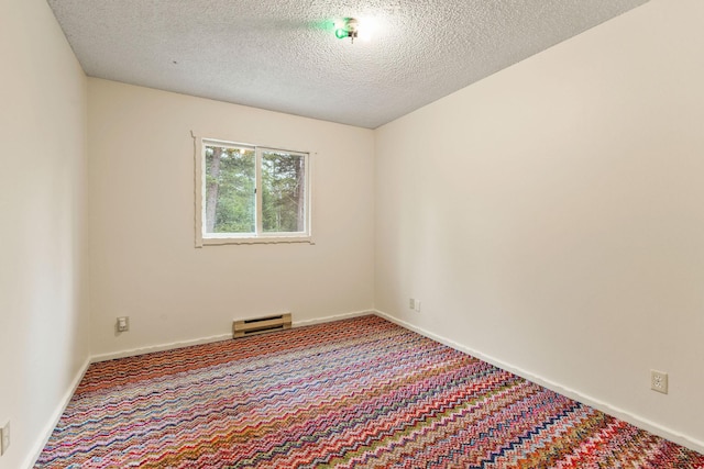 1255 Tamarack Ln, Columbia Falls, MT 59912 - unfurnished room featuring carpet flooring, baseboard heating, and a textured ceiling