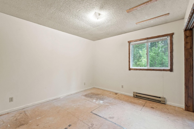 1255 Tamarack Ln, Columbia Falls, MT 59912 - empty room featuring a baseboard heating unit and a textured ceiling