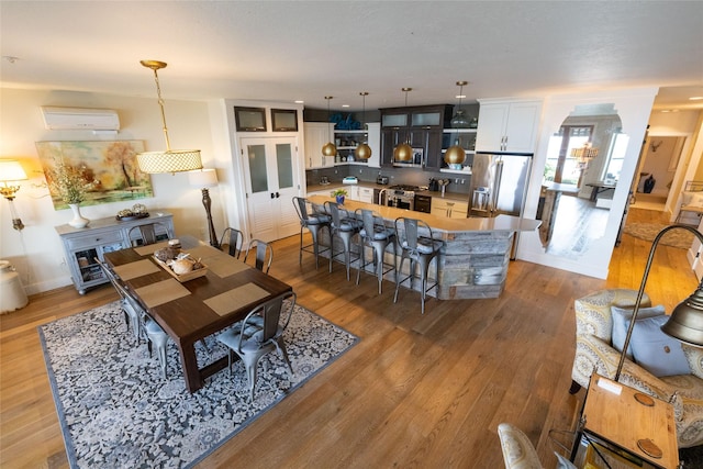 7175 US Highway 93 S, Lakeside, MT 59922 - living room with a wall unit AC, light wood-type flooring, and arched walkways
