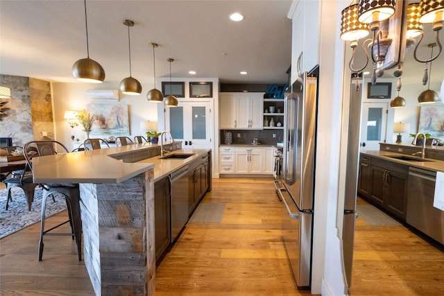 7175 US Highway 93 S, Lakeside, MT 59922 - kitchen featuring appliances with stainless steel finishes, open shelves, a kitchen breakfast bar, a large island, and white cabinets