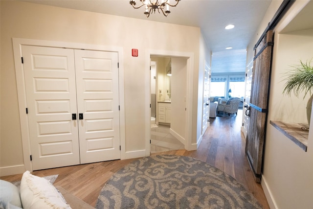 7175 US Highway 93 S, Lakeside, MT 59922 - corridor with wood finished floors, recessed lighting, a chandelier, and a barn door